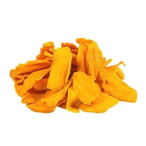 Pile of dried mango slices with golden-yellow color on white background